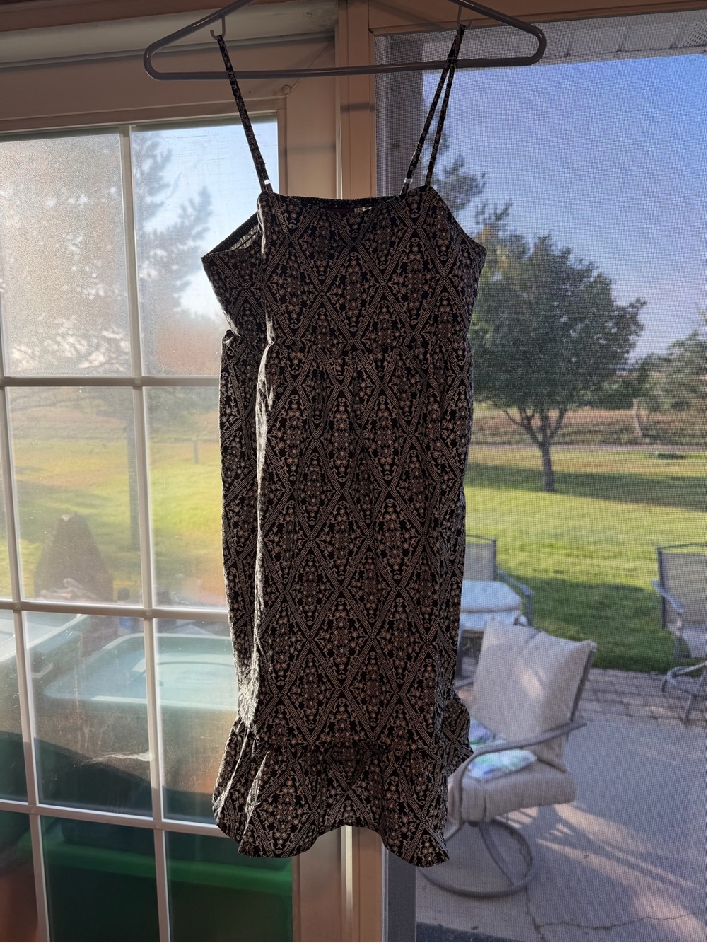 Black Printed Spaghetti Strap Mini Dress with Ruffle Hem. Bin 123